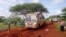 FILE - Kenyan security forces and others gather around the scene on an attack on a bus about 50 kilometers (31 miles) outside the town of Mandera, near the Somali border in northeastern Kenya, Nov. 22, 2014.