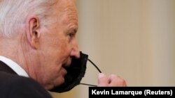 Le président américain Joe Biden enlevant son masque, le 9 septembre 2021 (Reuters).