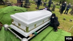 Wogene Debele of Takoma Park, Maryland, was eight months pregnant when she fell ill. She died from coronavirus shortly after giving birth. Here, her family mourns at her graveside. 