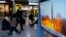 A TV shows a file image of North Korea's missile launch during a news program at the Seoul Railway Station in Seoul, South Korea, Jan. 11, 2022.