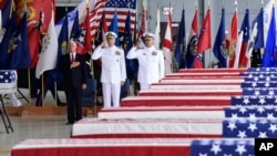 Vice President Mike Pence, left, Commander of U.S. Indo-Pacific Command Adm. Phil Davidson, center, and Rear Adm. Jon Kreitz, deputy director of the POW/MIA Accounting Agency, attend at a ceremony marking the arrival of the remains believed to be of American service members who f