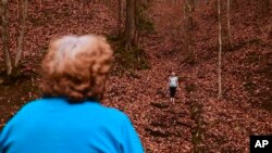 Maggie Hill, 67, watches Charity play in Madison, W.Va., on Thursday, Nov. 29, 2018. Hill adopted the 10-year-old girl about five years ago. Hill's son had been raising her but lost custody during his ongoing struggle with drug addiction, Hill said. 