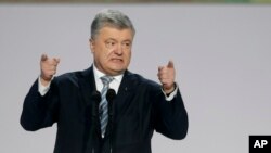 FILE - Then-Ukrainian President Petro Poroshenko gestures while speaking at a gathering with supporters in Kyiv, Ukraine, Jan. 29, 2019.