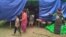 FILE - People displaced by fighting in northwestern Myanmar between junta forces and anti-junta fighters are seen at a camp in Chin state, Myanmar, May 31, 2021. 