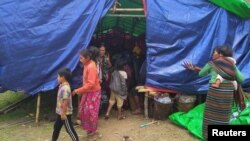 FILE - People displaced by fighting in northwestern Myanmar between junta forces and anti-junta fighters are seen at a camp in Chin state, Myanmar, May 31, 2021. 