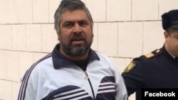 Əlizamin Salayev məhkəmədən aparılarkən