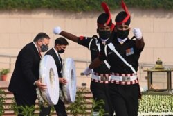 U.S. Secretary of State Mike Pompeo and U.S. Secretary of Defence Mark Esper lay wreaths at the National War Memorial in New Delhi, India, Oct. 27, 2020.