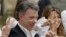 Colombia's President Juan Manuel Santos makes the victory sign after voting in a referendum to decide whether or not to support the peace deal he signed with rebels of the Revolutionary Armed Forces of Colombia, FARC, in Bogota, Colombia, Oct. 2, 2016. 