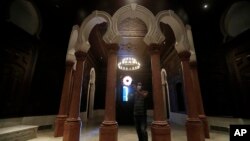 A museum worker takes pictures on a mobile phone of one of the reconstructed halls at the Sursock Museum that was damaged from the massive explosion in the nearby Beirut port, in Beirut, Lebanon, July 27, 2021. (AP Photo/Hussein Malla)