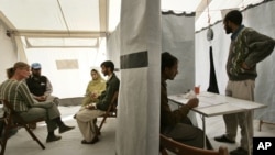 FILE - A man from the Pakistani Kashmiri village of Dak talks about his earthquake experiences during a psychotherapy session with psychologists of the MSF medical charity, at a tent clinic in the town of Bagh, Oct. 29, 2005.