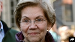 Sen. Elizabeth Warren speaks to reporters outside her home in Cambridge, Mass., after she exited the Democratic presidential race, March 5, 2020. Warren said April 23 that her brother Donald Herring had died the day before of COVID-19.
