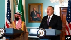Saudi Minister of Foreign Affairs Prince Faisal bin Farhan Al Saud listens as Secretary of State Mike Pompeo, right, speaks during their meeting at the State Department in Washington, Oct. 14, 2020.