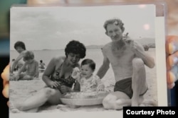 A 1984 photograph of American Charles Robert Jenkins and his wife and child on a beach. Anocha Panjoy’s family have identified her as the woman in the background.