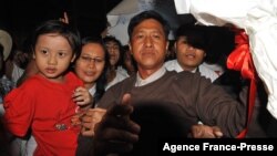 Kyaw Min Yu, center, known as Jimmy, and his wife, Ni Lar Thein, holding her child, in January 2012.