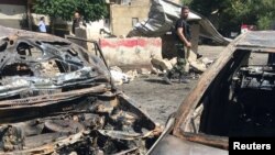 An army soldier secures the site of a suicide attack in Tahrir Square, in Damascus, Syria, July 2, 2017. 