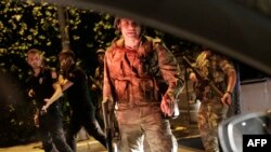 FILE - Turkish security officers detain Turkish police officers (in black) in Istanbul, during a security shutdown of the Bosphorus Bridge, July 15, 2016. 