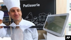 In this Jan. 8, 2019 photo shows the Google Assistant, which includes an "interpreter mode" that enables some of Google's smart home devices to work as a translator, at the Google display area at CES International in Las Vegas.