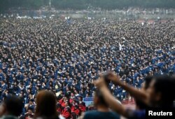 FILE - Students wearing academic gowns attend their graduation ceremony at Wuhan University in Hubei province, China, June 22, 2018.