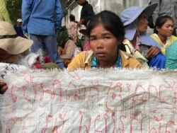 រូបឯកសារ៖ ស្ត្រីអ្នកតវ៉ា​មួយរូបកាន់​បដា​អំពាវនាវឲ្យមាន​ដំណោះស្រាយ​ដីធ្លី​នៅ​ក្រសួង​រៀបចំដែន​ដី​ ទីក្រុង​ភ្នំពេញ​ ថ្ងៃទី​២២​ ខែសីហា​ ឆ្នាំ​២០១៩។ (ហ៊ុល រស្មី/VOA)