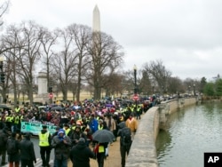Civil rights advocates march to honor the Rev. Martin Luther King Jr. in Washington, D.C., Jan. 14, 2017.