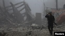 A member of Iraqi Federal police walks along destroyed buildings from clashes in the Old City of Mosul, Iraq, July 10, 2017.