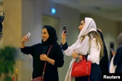 FILE - Saudi people attend the concert of composer Yanni at Princess Nourah bint Abdulrahman University in Riyadh, Saudi Arabia, Dec. 3, 2017.