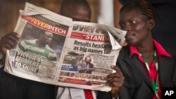 FILE - A Kenyan reads a copy of The Standard newspaper in Nairobi.