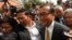 FILE - Sam Rainsy (R), leader of the opposition Cambodia National Rescue Party (CNRP), arrives at the Municipal Court in central Phnom Penh, Jan. 14, 2014. 