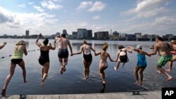 People jump into the Charles River during the "City Splash" event, July 18, 2017, in Boston, MA. (AP Photo/Elise Amendola)
