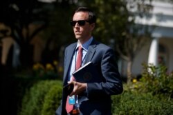 White House deputy press secretary Judd Deere waits for the arrival of President Donald Trump to the White House, Oct. 4, 2019, in Washington.