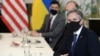 FILE - U.S. Secretary of State Antony Blinken, right, waits for the start of a meeting with Ukrainian Foreign Minister Dmytro Kuleba (seated opposite; not pictured), in Brussels, April 13, 2021. Blinken is due to meet with Kuleba in Kyiv next week.
