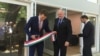 Ambassador László Szabó, center, looks on as Hungarian State Secretary for Economic Strategy László György, left, cuts a ribbon at the opening ceremony of a business promotion center in Washington, June 12, 2019. (Natalie Liu/VOA)