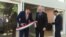 Ambassador László Szabó, center, looks on as Hungarian State Secretary for Economic Strategy László György, left, cuts a ribbon at the opening ceremony of a business promotion center in Washington, June 12, 2019. (Natalie Liu/VOA)
