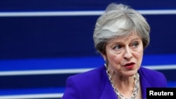 Britain's Prime Minister Theresa May speaks to the media as she arrives at the European Union leaders summit in Brussels, Belgium, Oct. 18, 2018.