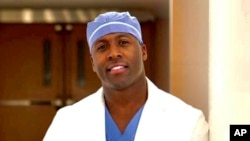 This March 30, 2020 photo shows Dr. Elvis Francois at the Mayo Clinic in Rochester, Minn. The orthopedic surgery resident has gone viral thanks to his top-notch musical performances at hospitals. 