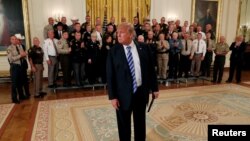 U.S. President Donald Trump approaches the news media to listen to a question about an anonymous op-ed from The New York Times after he held a gathering with sheriffs from across the U.S. in the East Room at the White House in Washington, Sept. 5, 2018. 