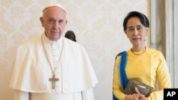 FILE - State Counsellor and Union Minister for Foreign Affairs of the Republic of the Union of Myanmar Aung San Suu Kyi, right, poses with Pope Francis on the occasion of their private audience, at the Vatican, May 4, 2017. 