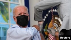U.S. President Joe Biden receives his coronavirus disease (COVID-19) booster vaccination in the Eisenhower Executive Office Building's South Court Auditorium at the White House on Sept. 27, 2021. 