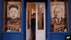 Artworks featuring U.S. President Donald Trump and North Korean leader Kim Jong Un are displayed at a gallery in Hanoi, Vietnam, Feb. 28, 2019. (AP Photo/Vincent Yu)
