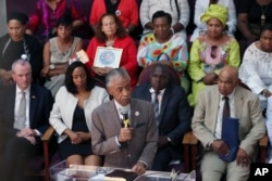 Rev. Al Sharpton, center at podium, speaks during services at Hope Memorial Baptist church, attended by many mothers of slain children, including Gwen Carr, mother of Eric Garner, Sunday, July 17, 2016, in Elizabeth, New Jersey.