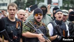 Armed pro-Russian separatists of the self-proclaimed Donetsk People's Republic pledge an oath during ceremony in the city of Donetsk, June 21, 2014. 