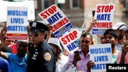 Community members take part in a protest to demand stop hate crime during the funeral service of Imam Maulama Akonjee, and Thara Uddin in the Queens borough of New York City, Aug. 15, 2016.