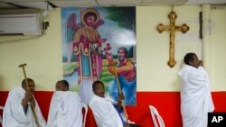 FILE - Eritrean Christian Orthodox migrants attend a mass at a makeshift church in Tel Aviv, Israel, May 7, 2016. 