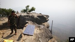 A Cambodian soldier talks on a phone from his position at the 11th-century Preah Vihear temple on the border between Thailand and Cambodia February 9, 2011. Thailand and Cambodia faced growing diplomatic pressure on Wednesday to end an armed standoff on a