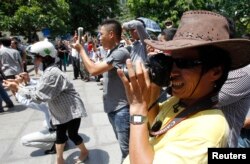 FILE - Blogger JB Nguyen Huu Vinh (front) takes photos while attending an anti-China protest in Hanoi.