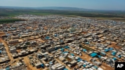 A large refugee camp on the Syrian side of the border with Turkey where many live in poor or war-ravaged countries that are ill-equipped to test for the virus or contain a possible outbreak.