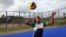 Florence Amara in action on the volleyball court, Freetown, Sierra Leone, July 22, 2015. (N. deVries/VOA News)
