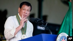 FILE - Philippine President Rodrigo Duterte gestures while addressing army troops during the 120th anniversary celebration of the Philippine Army, April 4, 2017 at Fort Bonifacio.