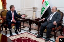 FILE - U.S. Defense Secretary Ash Carter meets with Iraqi Prime Minister Haider al-Abadi in the prime minister's office in Baghdad, Iraq, July 23, 2015.