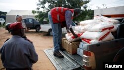 Aid workers load food onto a truck as flooding spreads in the aftermath of Cyclone Kenneth in Pemba, Mozambique, April 29, 2019. 